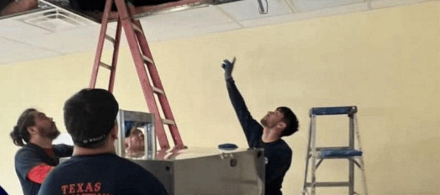 Texas Air Solutions techs working on a commercial HVAC install