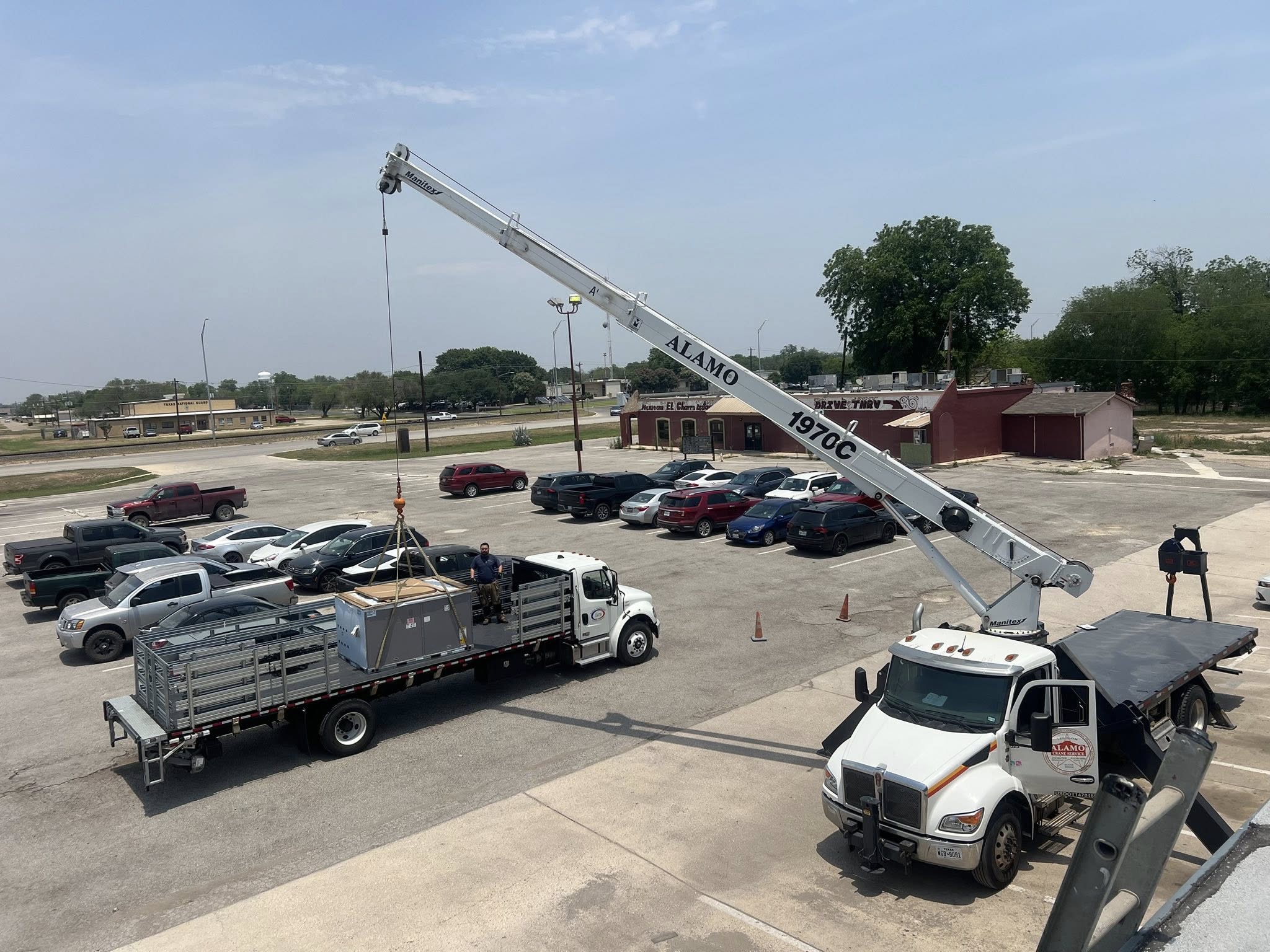 Texas Air Solutions trucks and crane on a commercial HVAC install in San Antonio